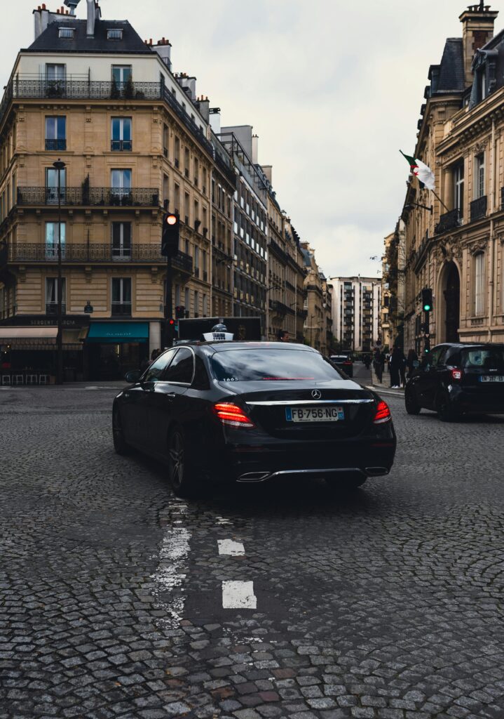 Taxi Standing at a Red Light in the Paris Old Town